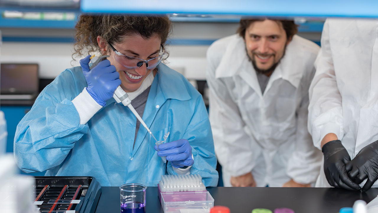 Michael Roberts is pictured sitting next to a bed while tending to a patient in his lab